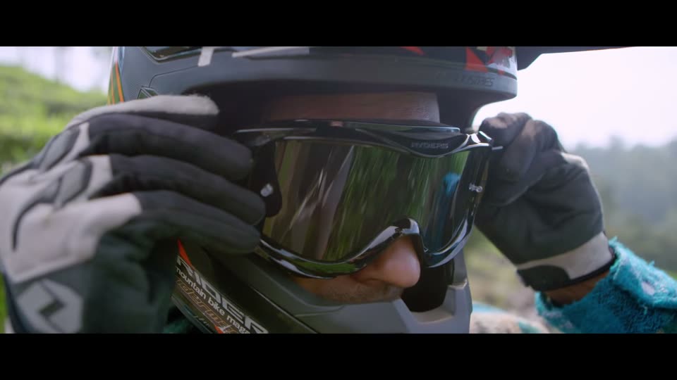 A rider adjusts goggles before a trail run