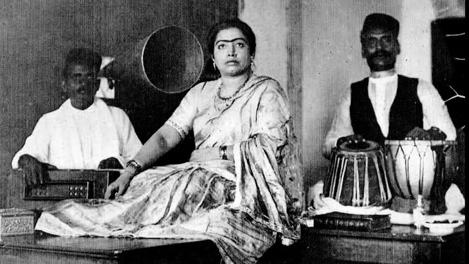 Archival photograph of an early Indian recording session with a gramophone horn